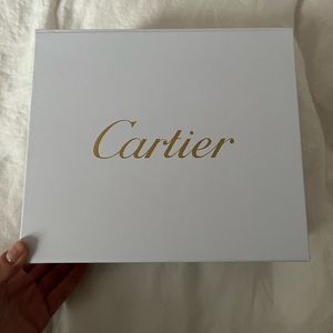 Cartier box and red bag, no jewelry or items inside. Packaging only.